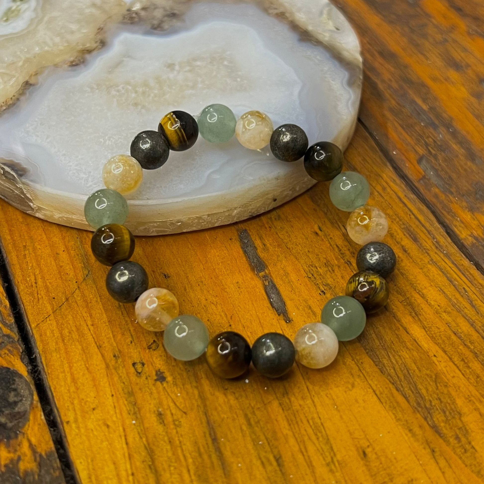 Beaded bracelet with multicolored beads on a wooden surface