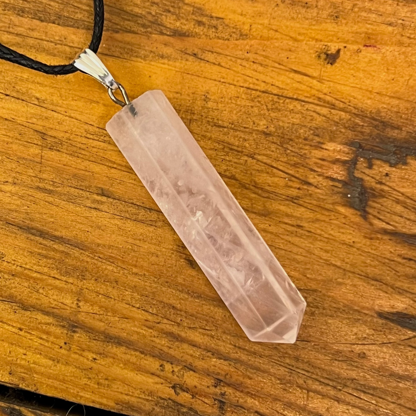 Crystal pendant necklace on a wooden surface