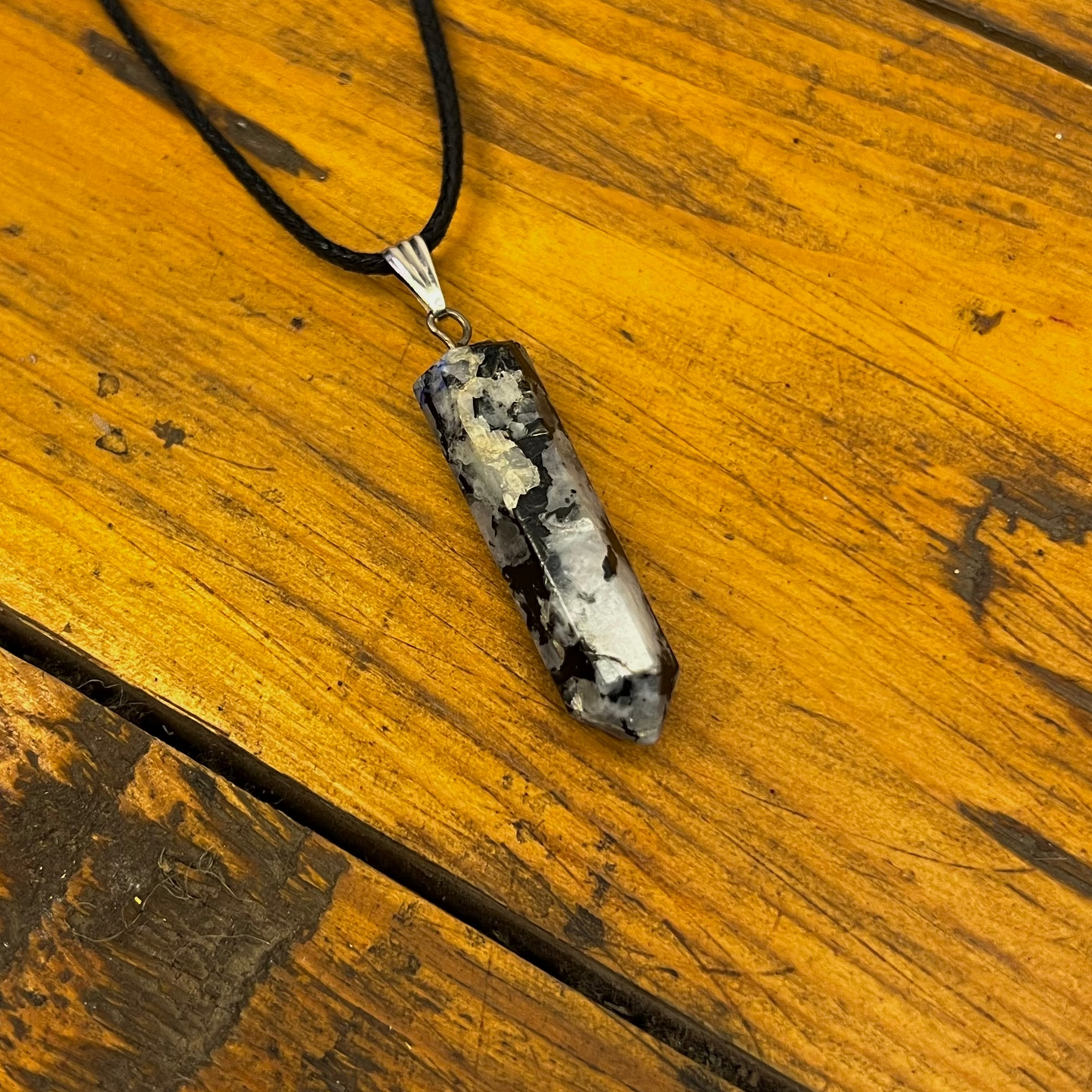 Necklace with a pendant on a wooden surface