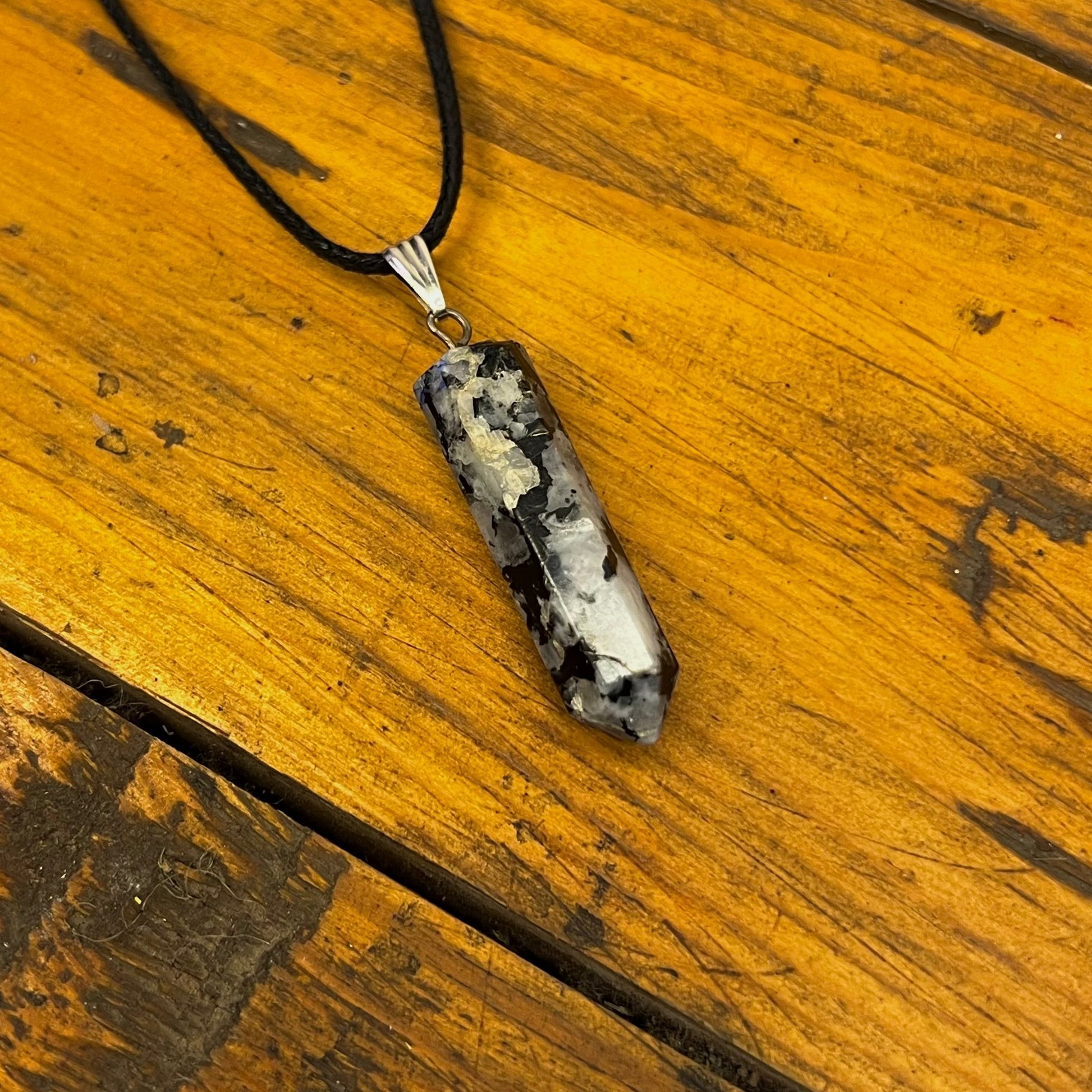 Necklace with a pendant on a wooden surface