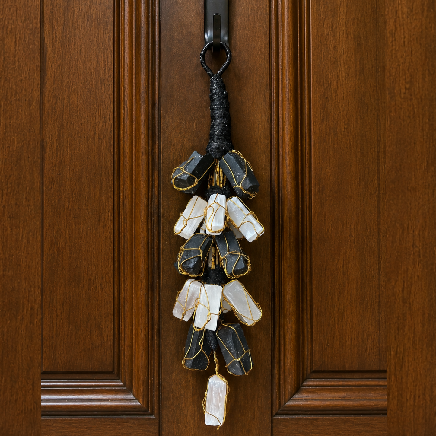 Decorative keychain with stones hanging on a wooden door