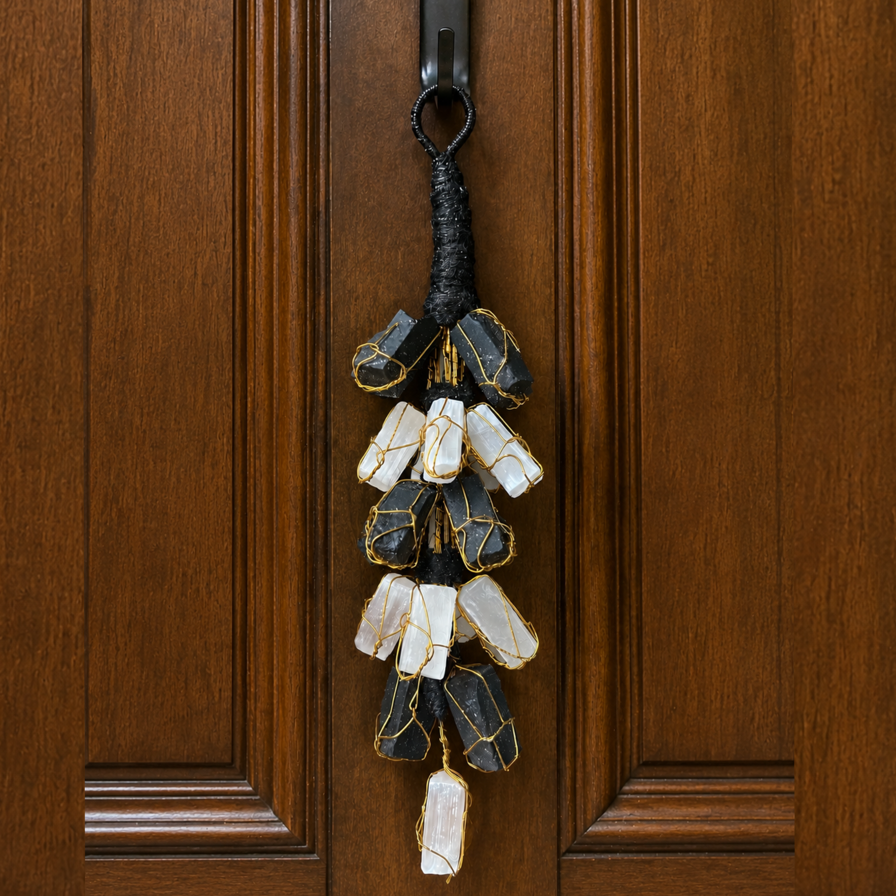 Decorative keychain with stones hanging on a wooden door